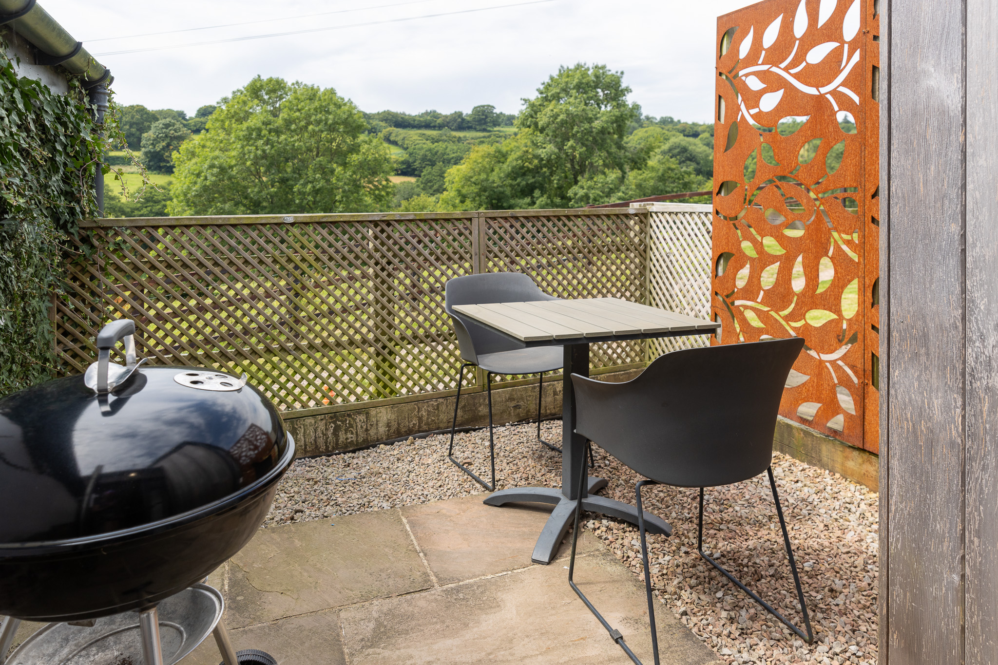 The Blorenge enclosed terrace with barbecue, table and two chairs, and privacy screen.